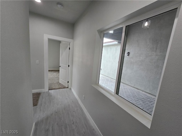 corridor with hardwood / wood-style flooring