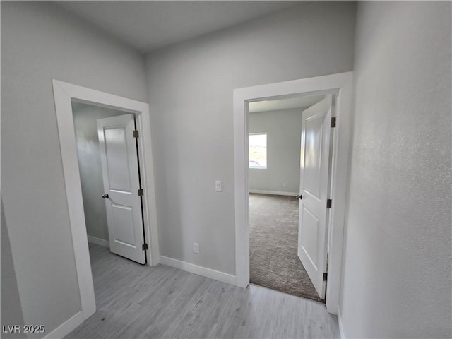 corridor with light hardwood / wood-style flooring