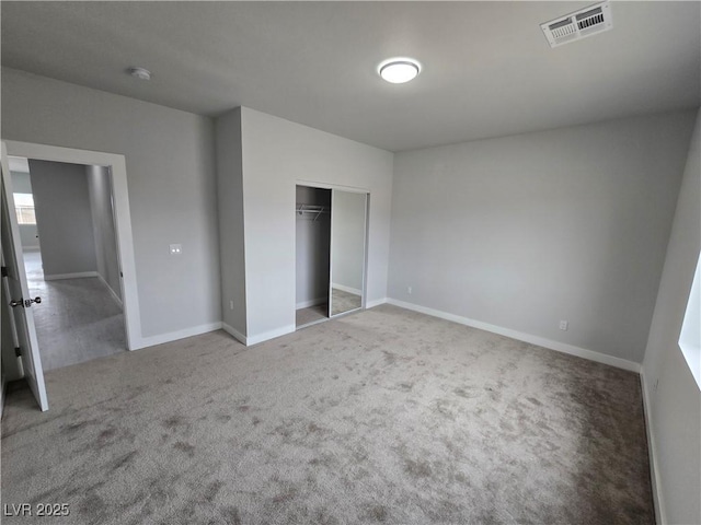 unfurnished bedroom with carpet and a closet