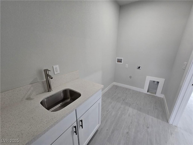 laundry room with sink, cabinets, washer hookup, hookup for an electric dryer, and light wood-type flooring