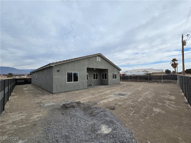 back of house featuring a mountain view