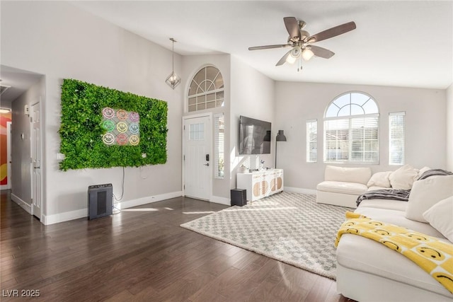 living room with vaulted ceiling, ceiling fan, baseboards, and wood finished floors