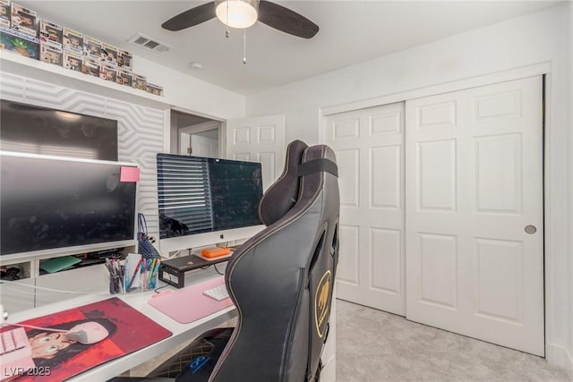 office area with ceiling fan and light carpet