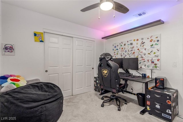 carpeted office featuring visible vents and a ceiling fan