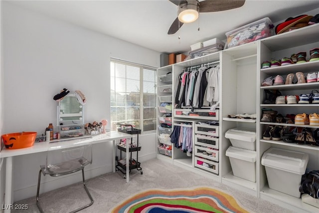 spacious closet featuring ceiling fan and light carpet