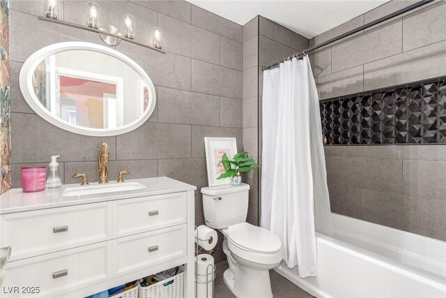 full bathroom with shower / bath combo, tile walls, vanity, and toilet