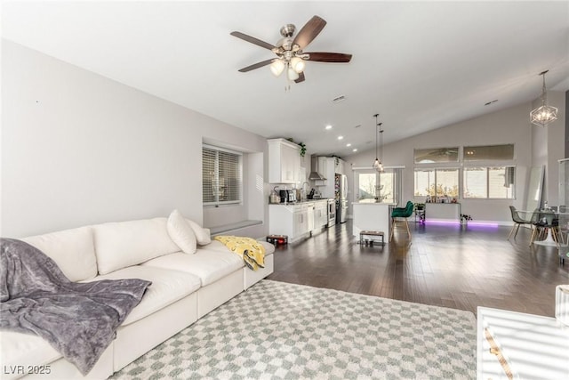 living area with recessed lighting, a ceiling fan, baseboards, vaulted ceiling, and dark wood finished floors