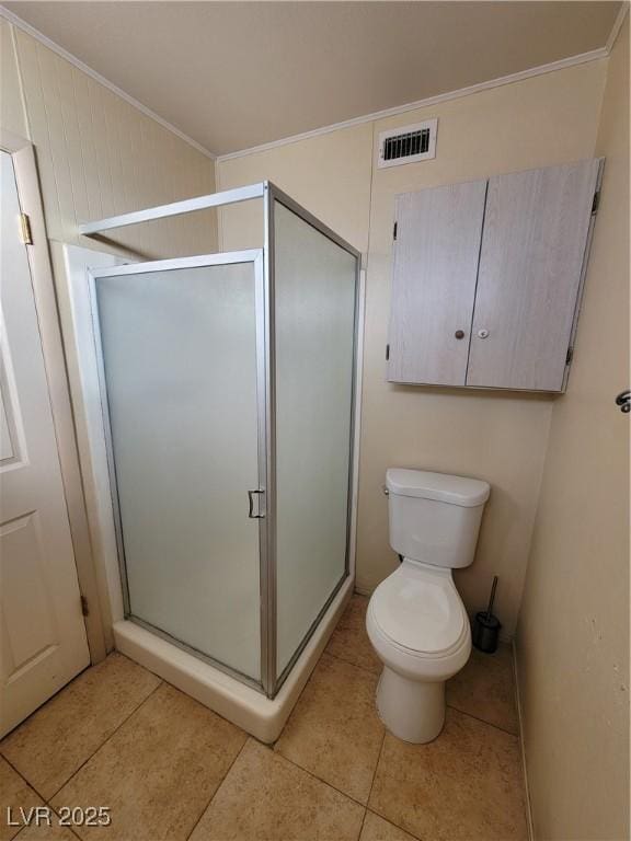 bathroom featuring crown molding, an enclosed shower, tile patterned floors, and toilet