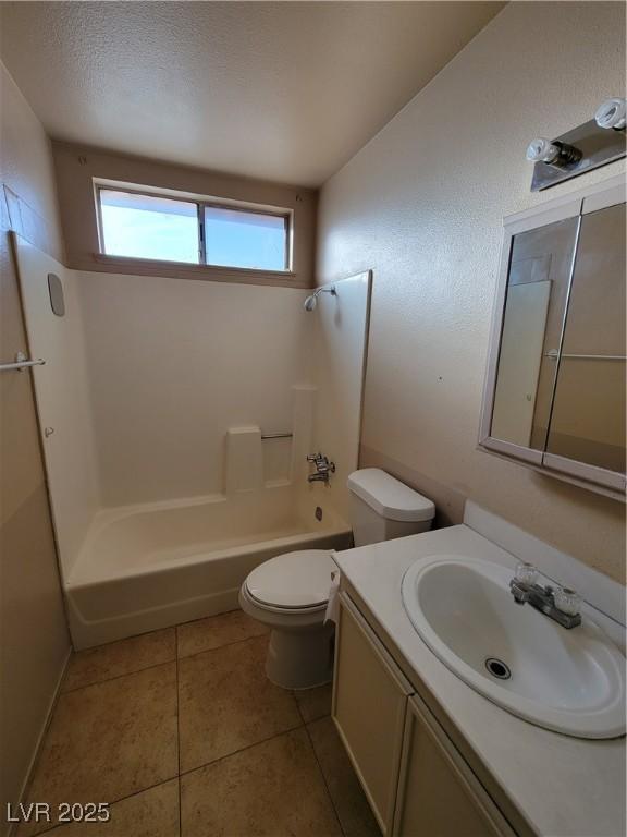 full bathroom featuring vanity, tile patterned floors, bathing tub / shower combination, and toilet