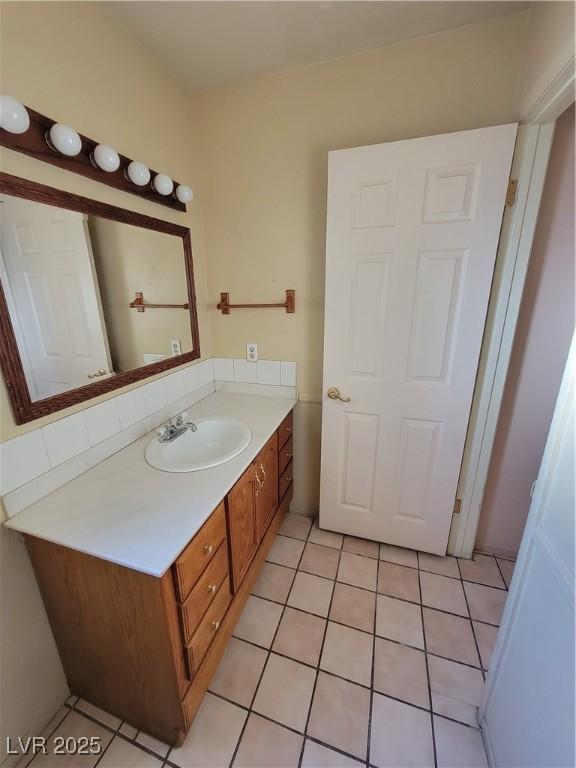 bathroom featuring tile patterned flooring and vanity