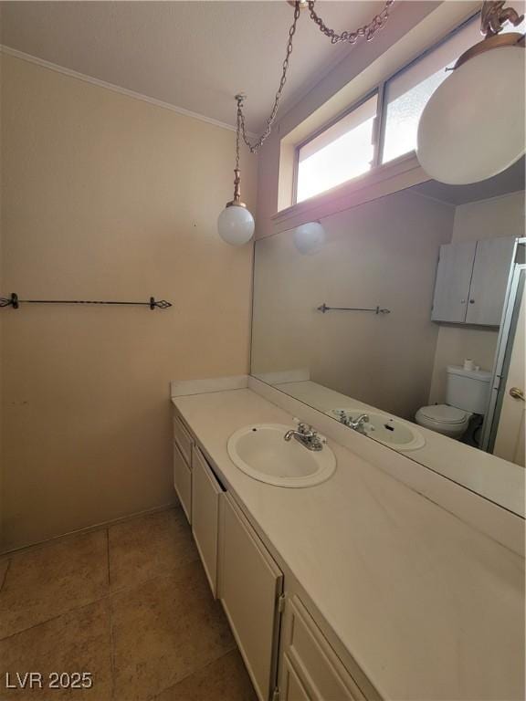 bathroom with vanity, tile patterned flooring, ornamental molding, and toilet