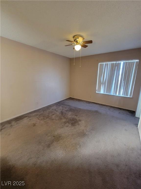 carpeted empty room with ceiling fan