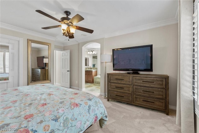 carpeted bedroom featuring ceiling fan, ensuite bathroom, and ornamental molding