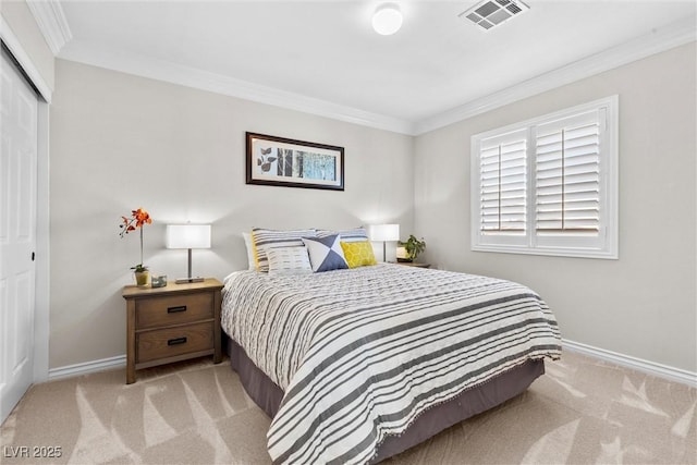 bedroom featuring crown molding, light colored carpet, and a closet