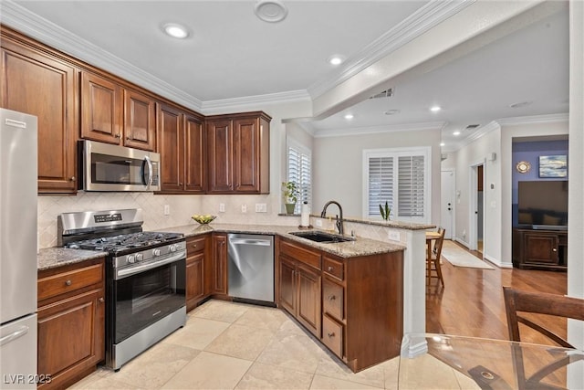 kitchen featuring light tile patterned flooring, sink, kitchen peninsula, stainless steel appliances, and light stone countertops