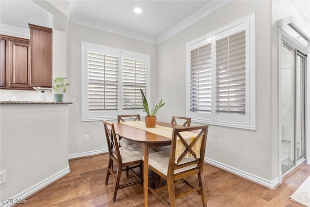 dining area featuring crown molding and hardwood / wood-style floors