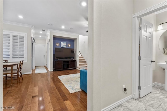 hallway featuring hardwood / wood-style floors and crown molding