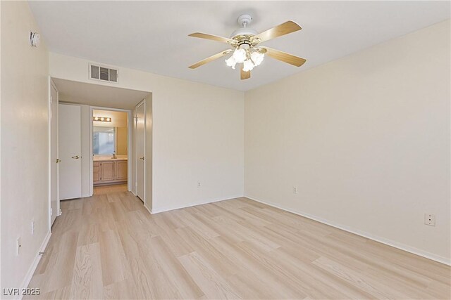 empty room with ceiling fan and light wood-type flooring