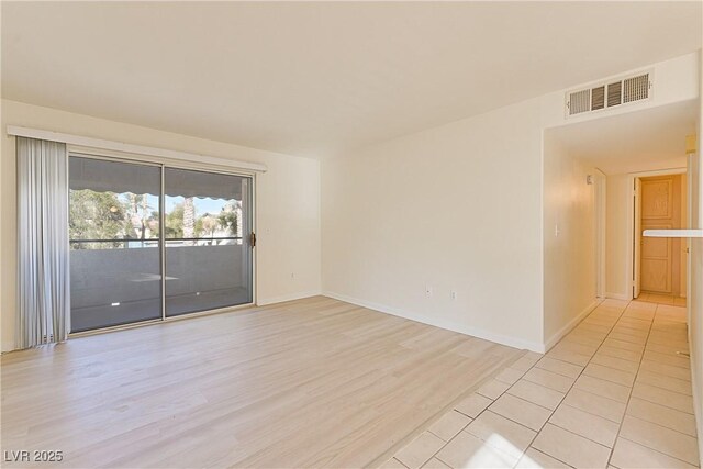 empty room with light hardwood / wood-style flooring