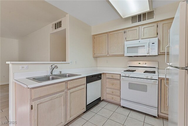 kitchen with sink, light tile patterned floors, light brown cabinets, kitchen peninsula, and white appliances