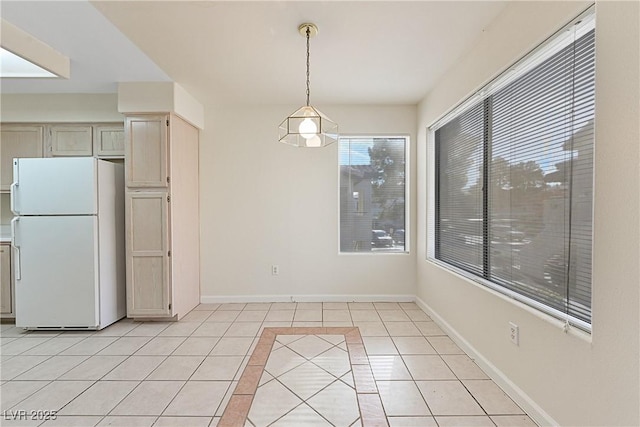 unfurnished dining area featuring light tile patterned floors