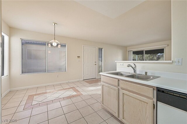 kitchen with light tile patterned floors, sink, dishwasher, decorative light fixtures, and light brown cabinets