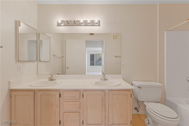 full bathroom featuring tile patterned floors, vanity, toilet, and  shower combination