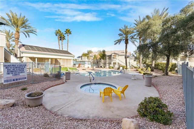 view of pool featuring a community hot tub and a patio area