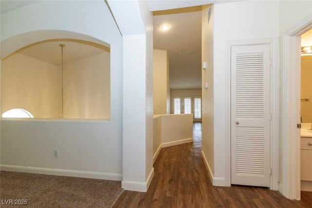 hallway with dark hardwood / wood-style flooring