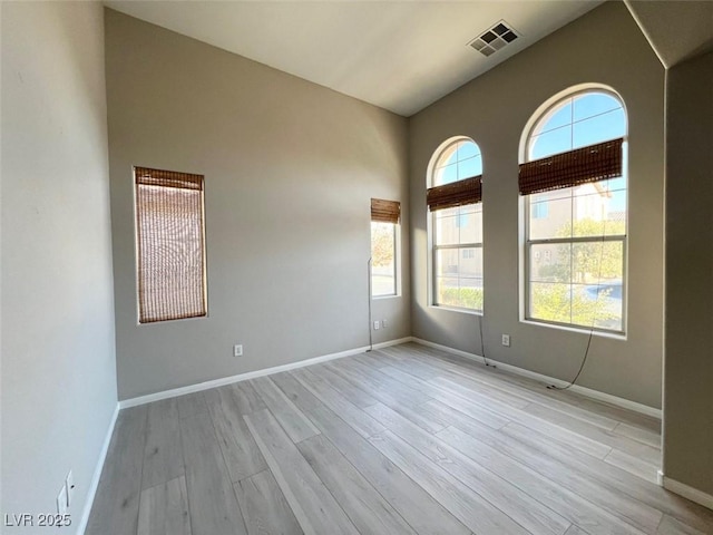 spare room with light hardwood / wood-style flooring