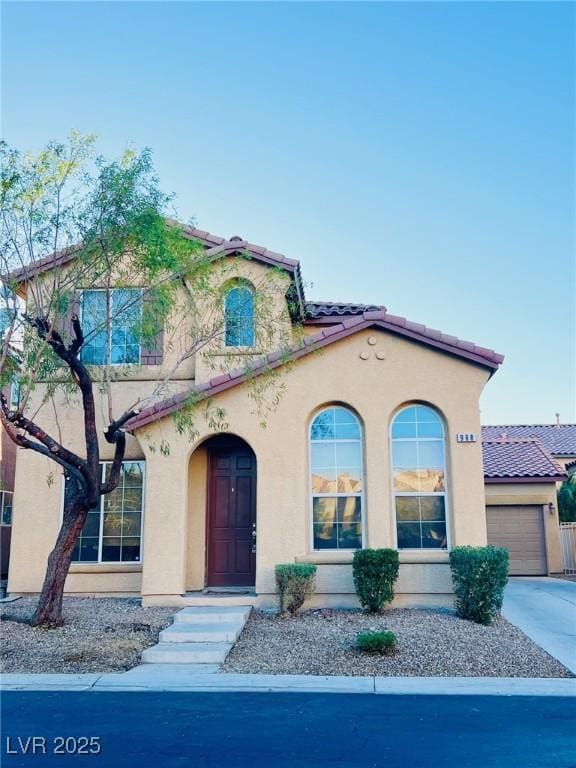 mediterranean / spanish-style house with a garage