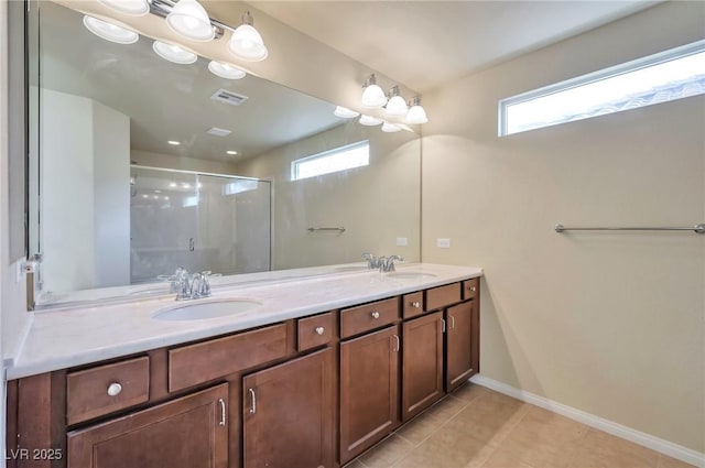 bathroom with vanity, tile patterned floors, plenty of natural light, and a shower with door