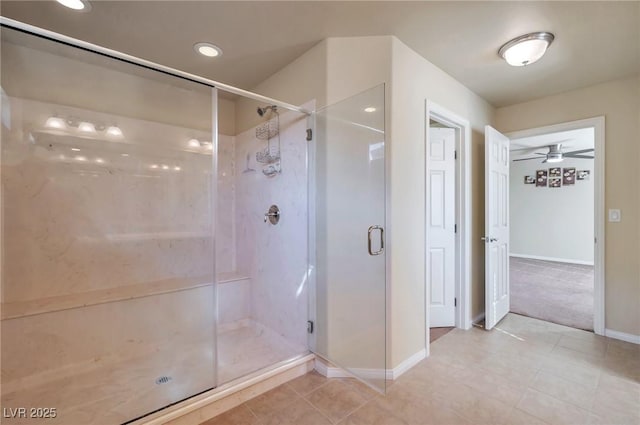 bathroom with a shower with door and tile patterned flooring