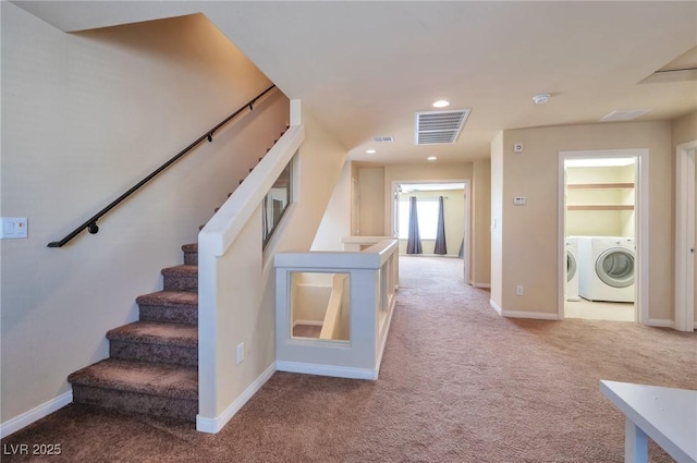 hallway featuring washer and dryer and light carpet