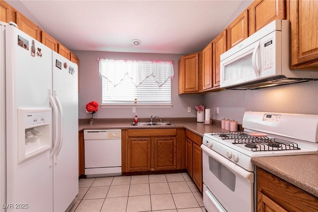 kitchen with white appliances, sink, and light tile patterned floors