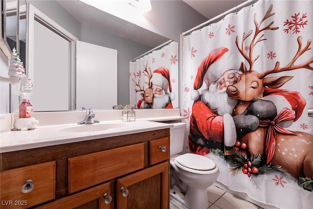 bathroom featuring vanity, toilet, and tile patterned flooring