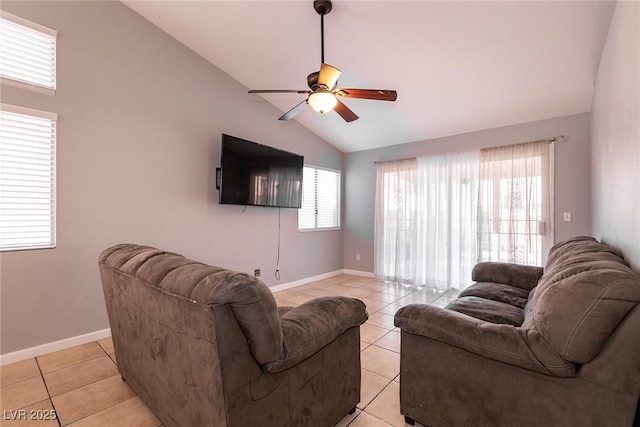 tiled living room with ceiling fan, vaulted ceiling, and a healthy amount of sunlight