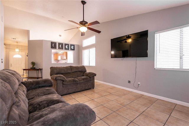 living room with lofted ceiling, light tile patterned floors, and ceiling fan