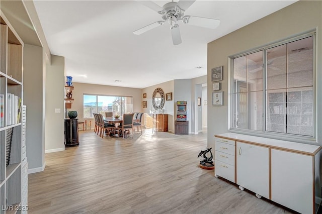 dining room with ceiling fan and light wood-type flooring