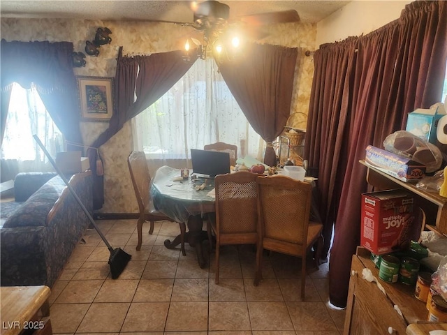 dining space with light tile patterned flooring and ceiling fan