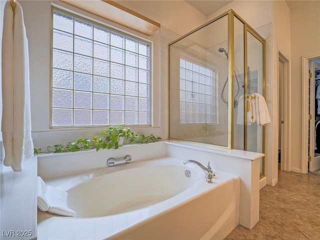 bathroom featuring tile patterned floors and shower with separate bathtub