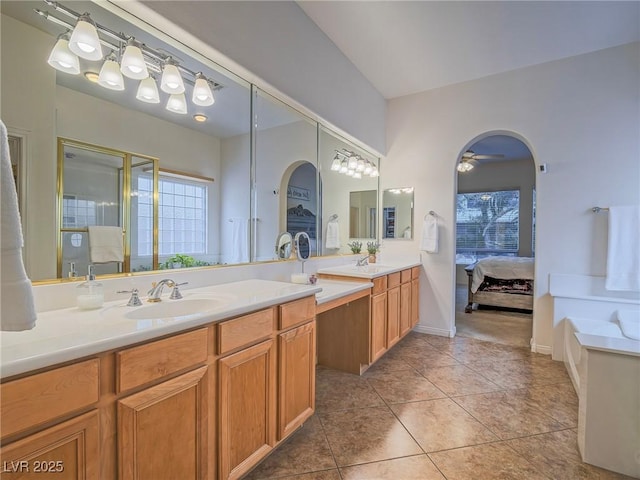 bathroom with vanity, a wealth of natural light, tile patterned floors, and walk in shower