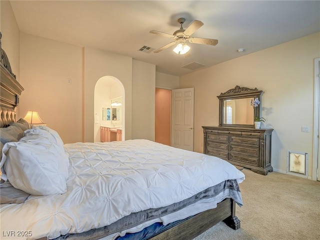 carpeted bedroom featuring ceiling fan and ensuite bathroom