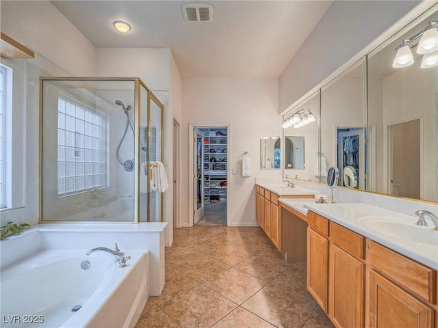 bathroom featuring vanity, tile patterned flooring, and separate shower and tub