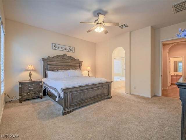 carpeted bedroom with connected bathroom and ceiling fan