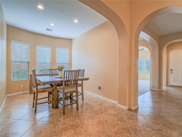 dining room featuring light tile patterned floors and a healthy amount of sunlight