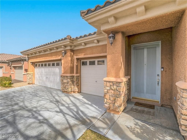 view of exterior entry with a garage