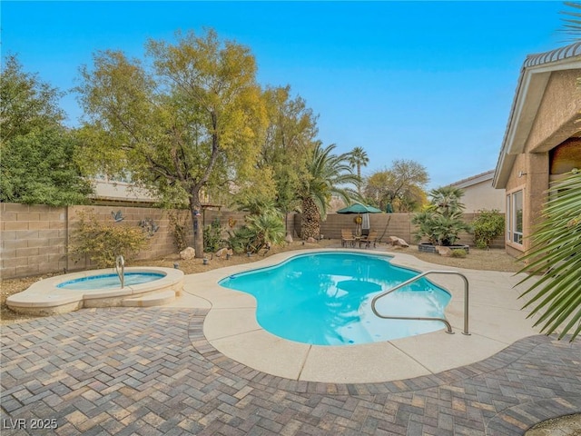 view of pool with a patio and an in ground hot tub