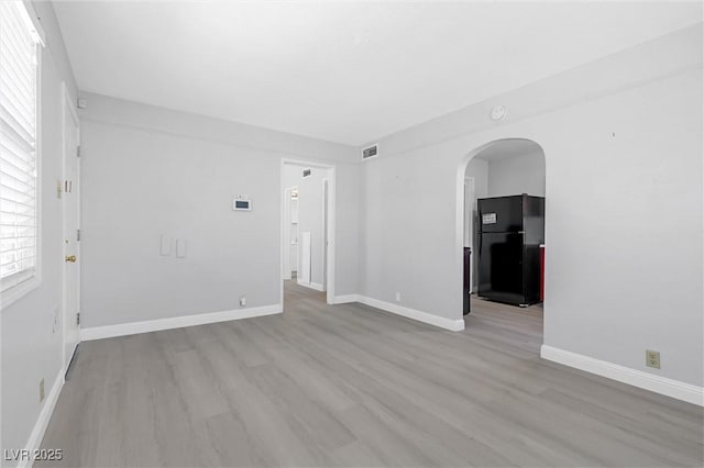 empty room with light hardwood / wood-style floors