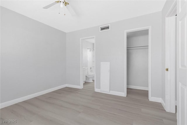 unfurnished bedroom with ceiling fan, connected bathroom, a closet, and light hardwood / wood-style flooring